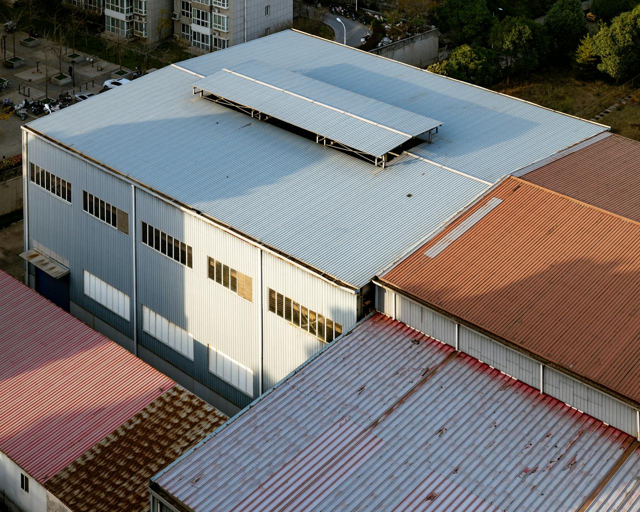 gallery-04 Aerial shot showcasing industrial building roofs with varying colors in Luoyang, China.